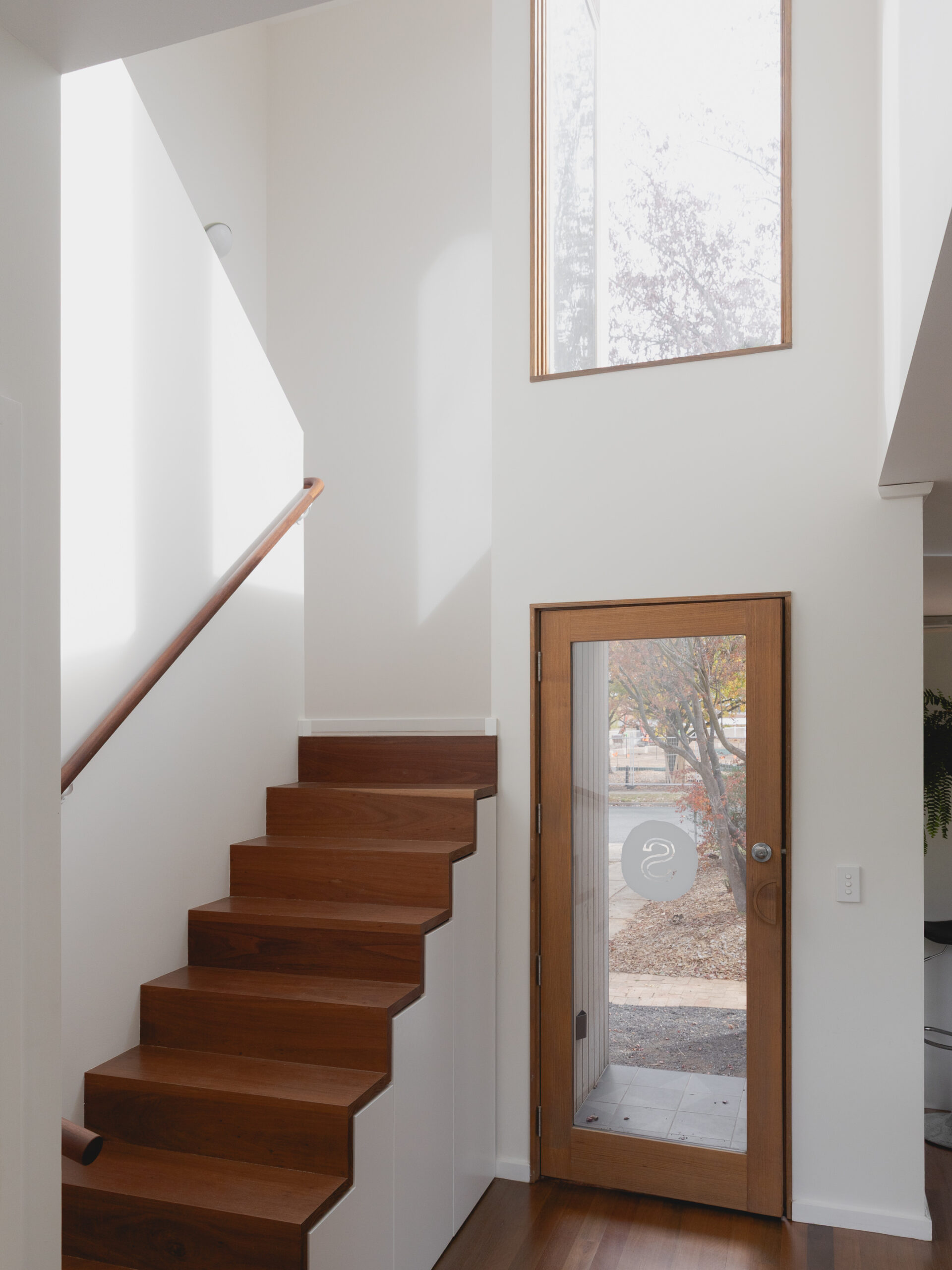 Image shows a staircase with north-facing windows bringing in light 