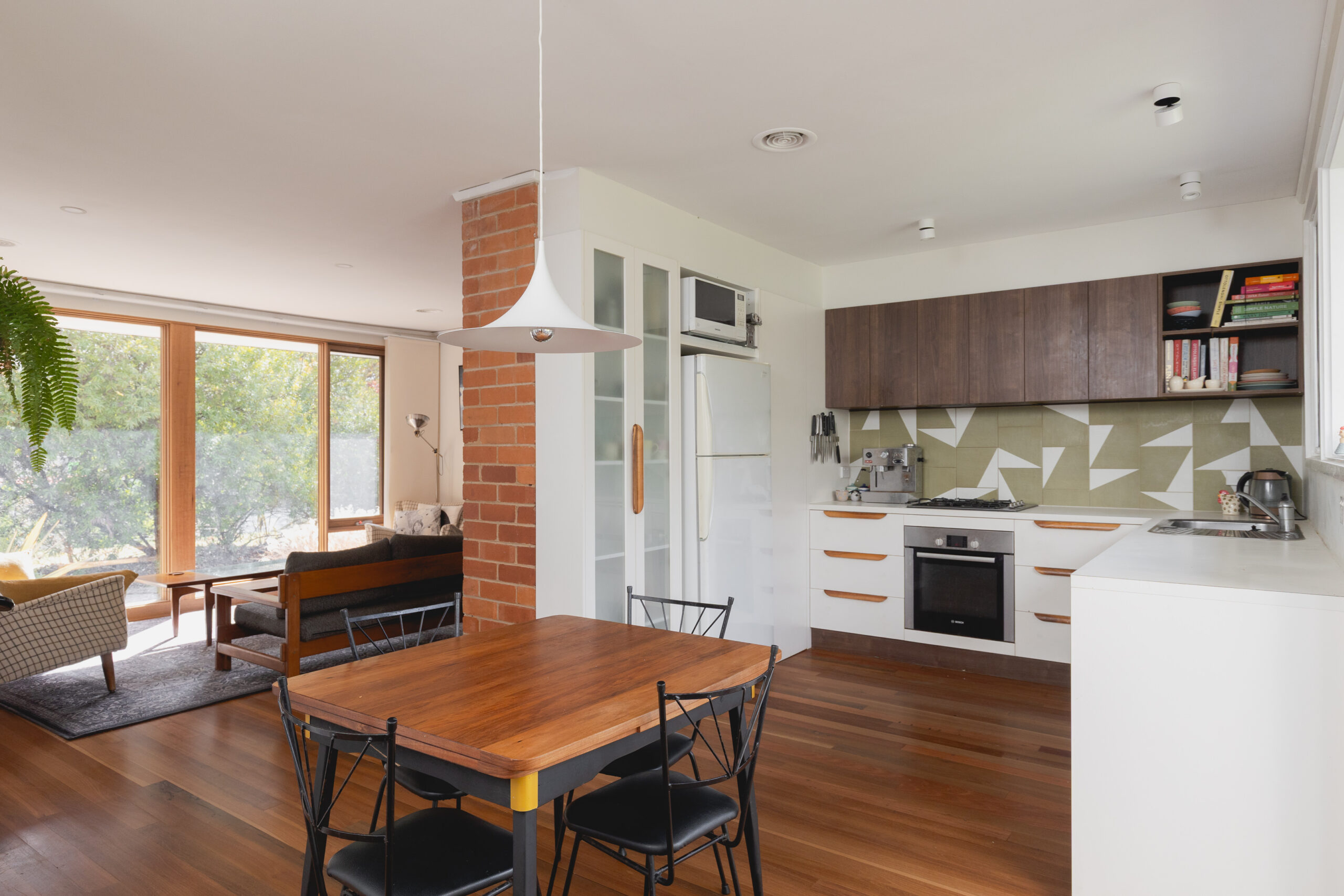 Image shows a renovated kitchen and living room.